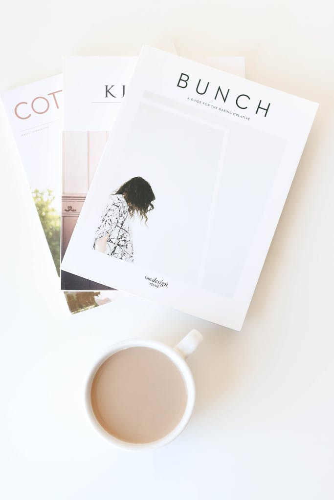 Stylish Flat Lay Of Magazines With A Coffee Cup On A White Table. Perfect For Relaxation And Reading Inspiration. 4067117 683x1024