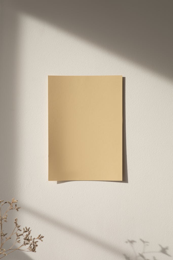 a minimalist mockup of beige paper on a sunlit wall perfect for design presentations. 8533218 683x1024.jpg